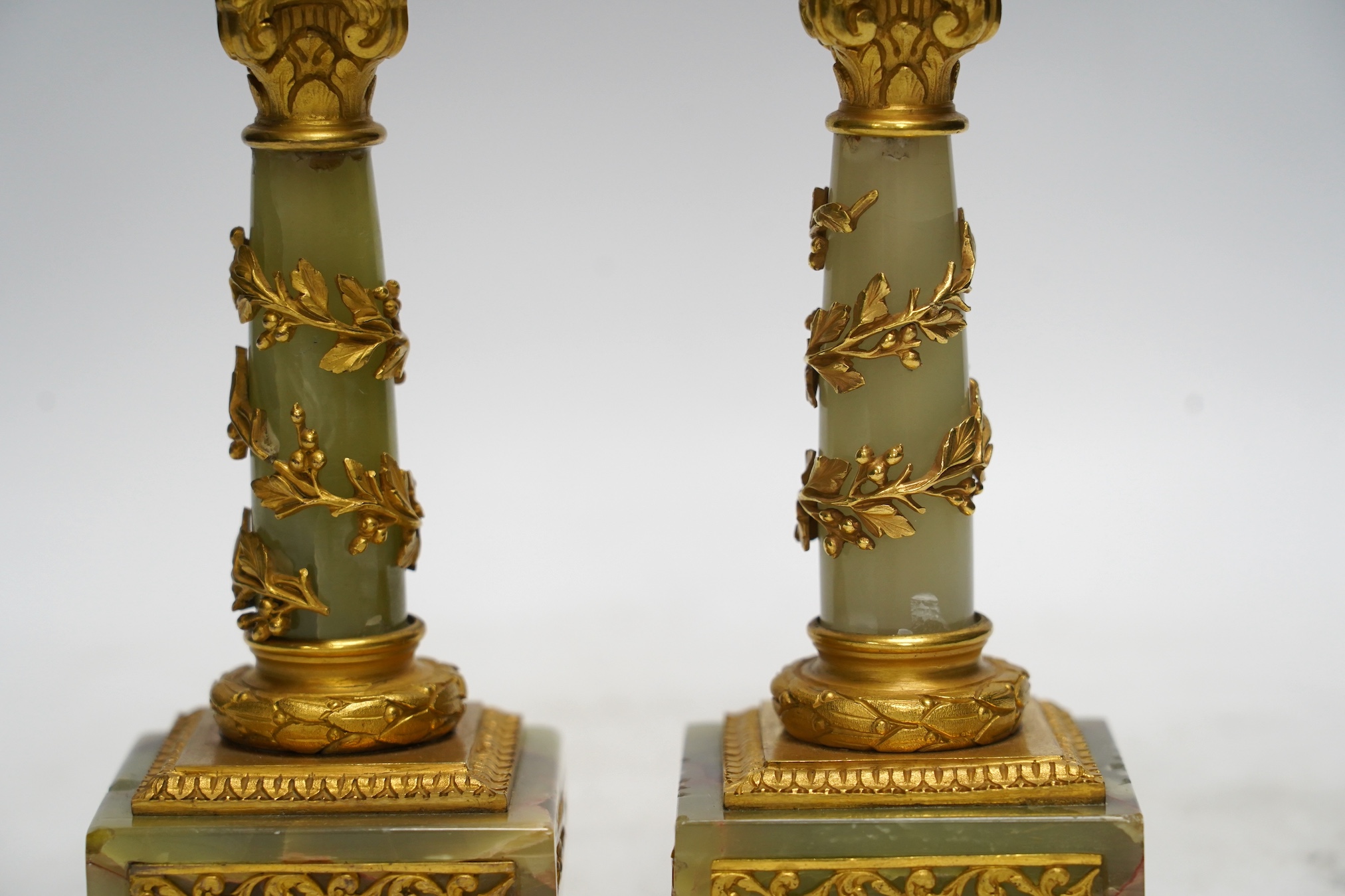 A pair of early 20th century French ormolu mounted onyx candlesticks, 20cm high